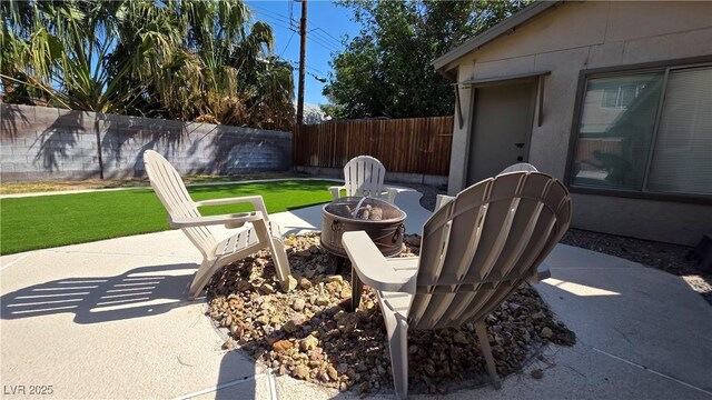 4512 Mark Ave, Las Vegas, NV 89108 - fenced backyard with an outdoor fire pit and a patio
