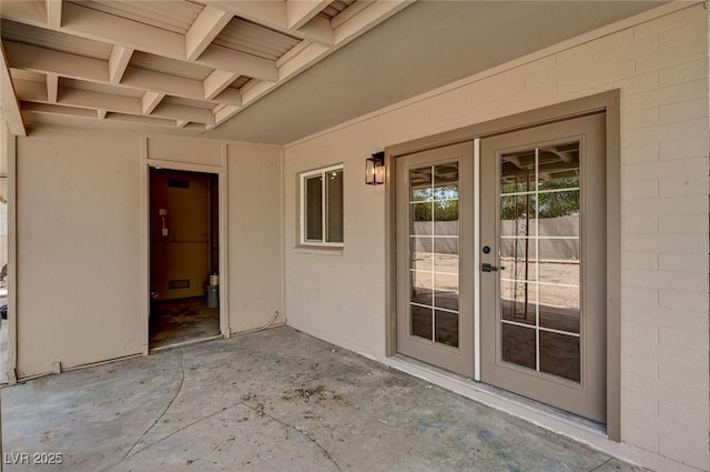 4804 Apawana Ln, Las Vegas, NV 89108 - doorway to property with french doors, a patio, and concrete block siding