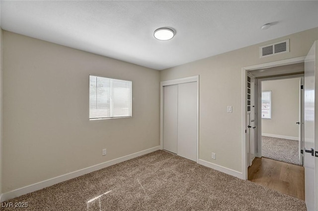 4804 Apawana Ln, Las Vegas, NV 89108 - unfurnished bedroom featuring multiple windows, a closet, and carpet