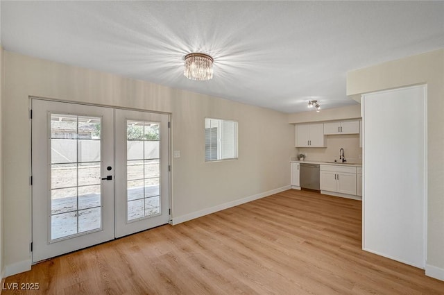 4804 Apawana Ln, Las Vegas, NV 89108 - doorway to outside with french doors, light wood finished floors, and a chandelier