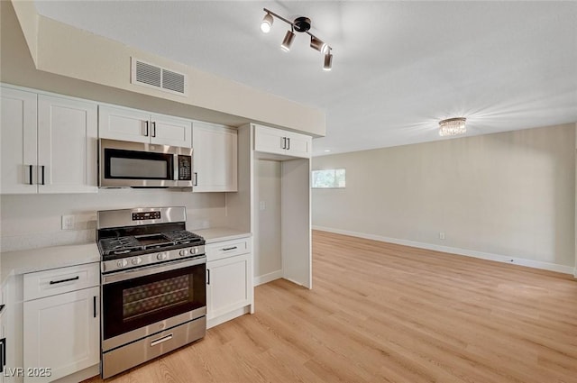 4804 Apawana Ln, Las Vegas, NV 89108 - kitchen featuring appliances with stainless steel finishes, light countertops, and white cabinets