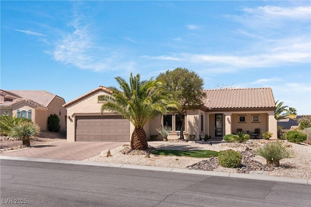 2606 Crested Butte St, Henderson, NV 89052 - view of front of house with a garage, driveway, stucco siding, and a tile roof