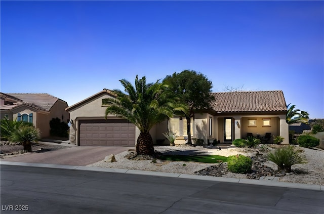 2606 Crested Butte St, Henderson, NV 89052 - view of front of property featuring a garage, stucco siding, concrete driveway, and a tiled roof