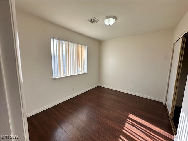1332 Wheatland Way, Las Vegas, NV 89128 - unfurnished bedroom featuring dark wood-type flooring and a closet