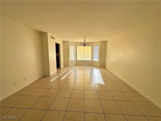 1332 Wheatland Way, Las Vegas, NV 89128 - empty room featuring a chandelier and light tile patterned flooring
