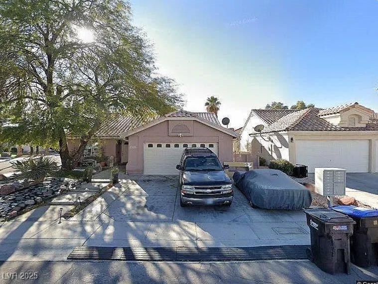 2305 Lone Ridge Ct, North Las Vegas, NV 89032 - single story home featuring a garage, concrete driveway, stucco siding, and a tile roof