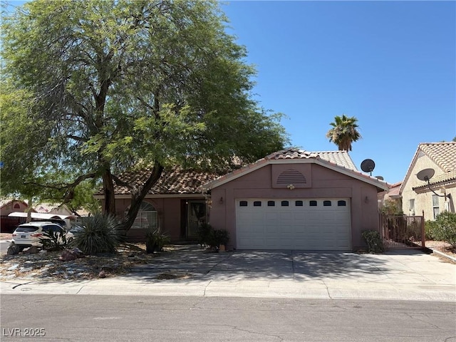 2305 Lone Ridge Ct, North Las Vegas, NV 89032 - view of front of property with a tiled roof, stucco siding, a garage, and concrete driveway