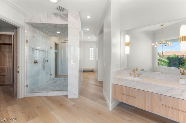 8617 Titleist Cir, Las Vegas, NV 89117 - full bath featuring crown molding, a marble finish shower, wood finished floors, vanity, and recessed lighting
