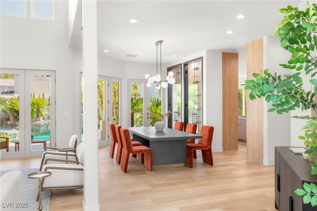 8617 Titleist Cir, Las Vegas, NV 89117 - dining area with french doors, recessed lighting, light wood-style floors, a chandelier, and healthy amount of natural light