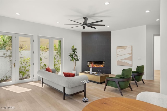 8617 Titleist Cir, Las Vegas, NV 89117 - living room with light wood-type flooring, recessed lighting, a ceiling fan, and a large fireplace