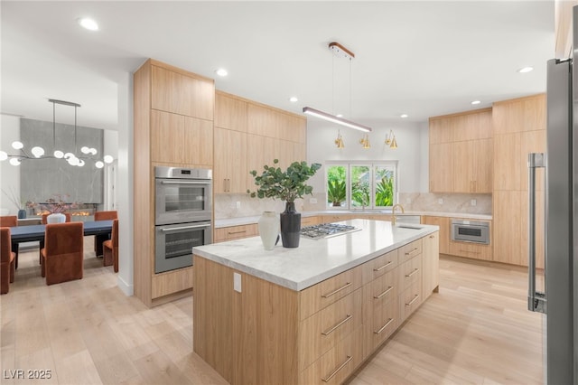 8617 Titleist Cir, Las Vegas, NV 89117 - kitchen featuring modern cabinets, stainless steel appliances, light brown cabinets, tasteful backsplash, and recessed lighting
