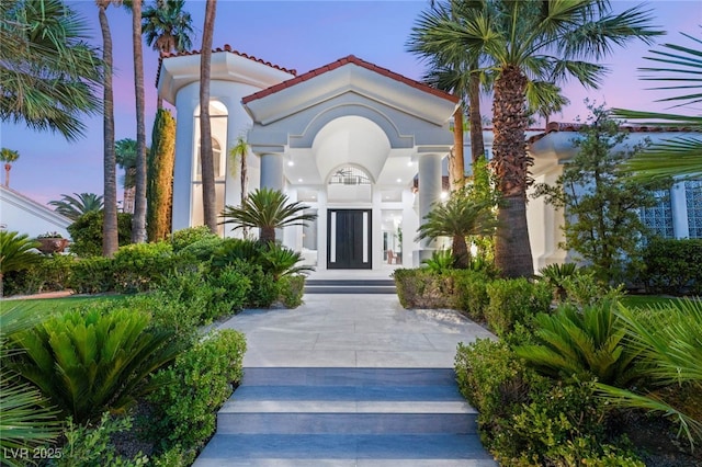 8617 Titleist Cir, Las Vegas, NV 89117 - property entrance with stucco siding and a tiled roof