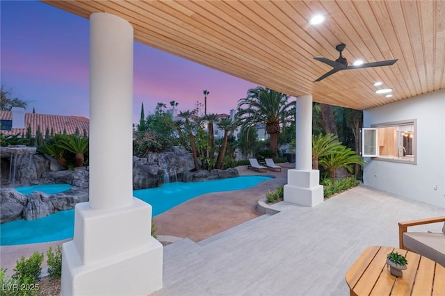 8617 Titleist Cir, Las Vegas, NV 89117 - pool at dusk featuring a patio area, a ceiling fan, and an outdoor pool