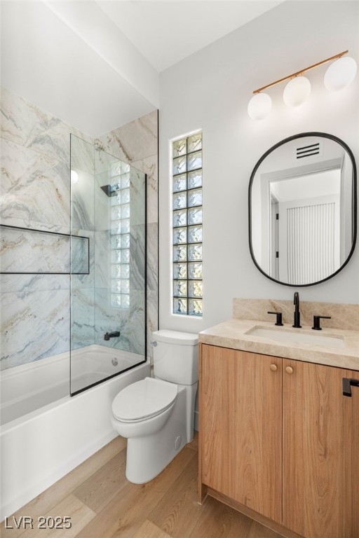 8617 Titleist Cir, Las Vegas, NV 89117 - full bathroom featuring wood finished floors, vanity, and tub / shower combination