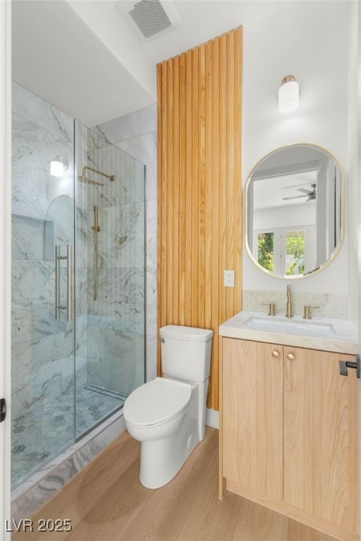 8617 Titleist Cir, Las Vegas, NV 89117 - full bath featuring wood finished floors, a marble finish shower, vanity, and ceiling fan