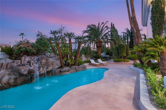 8617 Titleist Cir, Las Vegas, NV 89117 - pool at dusk featuring a patio area and an outdoor pool