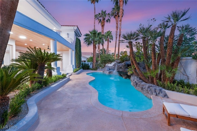 8617 Titleist Cir, Las Vegas, NV 89117 - pool at dusk featuring a patio area and an outdoor pool
