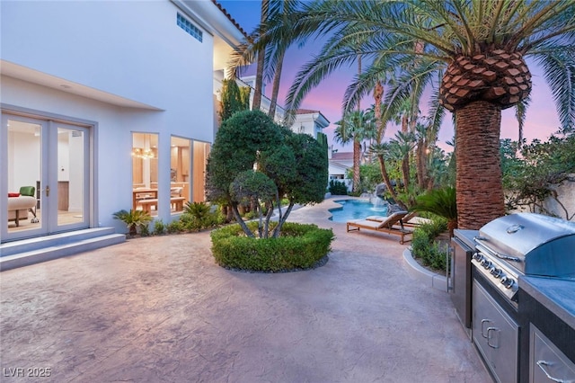 8617 Titleist Cir, Las Vegas, NV 89117 - view of patio with french doors, an outdoor pool, and exterior kitchen