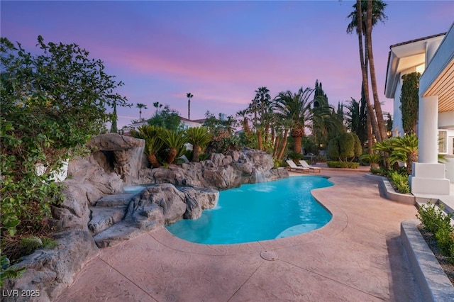 8617 Titleist Cir, Las Vegas, NV 89117 - pool at dusk featuring a patio and an outdoor pool