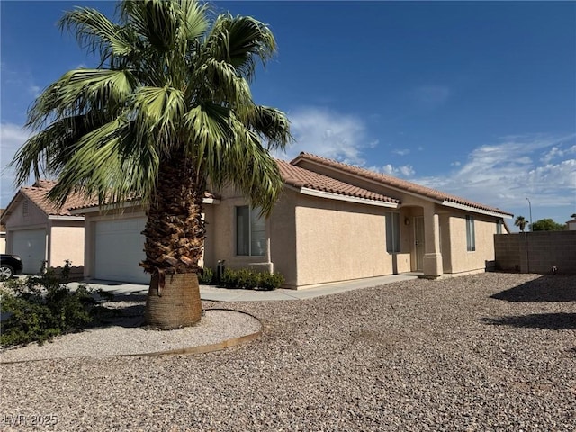 621 Carlos Julio Ave, North Las Vegas, NV 89031 - view of front of home featuring stucco siding, a tiled roof, and an attached garage