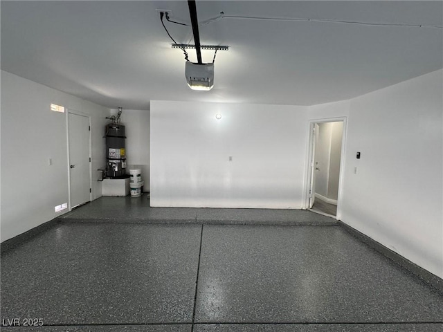 621 Carlos Julio Ave, North Las Vegas, NV 89031 - garage featuring strapped water heater and a garage door opener