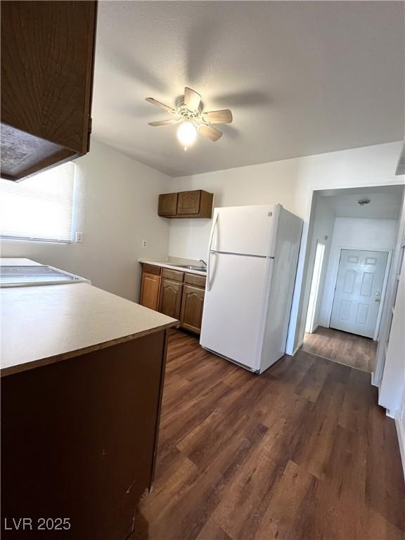2170 W Gally Rd, Pahrump, NV 89060 - kitchen with freestanding refrigerator, dark wood finished floors, ceiling fan, and light countertops