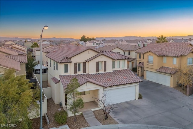 6005 Bristol Crest Ln, Las Vegas, NV 89139 - view of front of house with driveway, a residential view, stucco siding, and a tiled roof