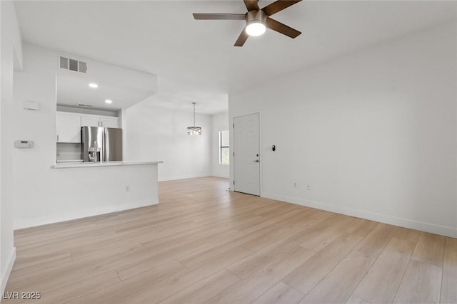 8250 N Grand Canyon Dr Unit 1050, Las Vegas, NV 89166 - unfurnished living room with a ceiling fan, light wood finished floors, a chandelier, and recessed lighting