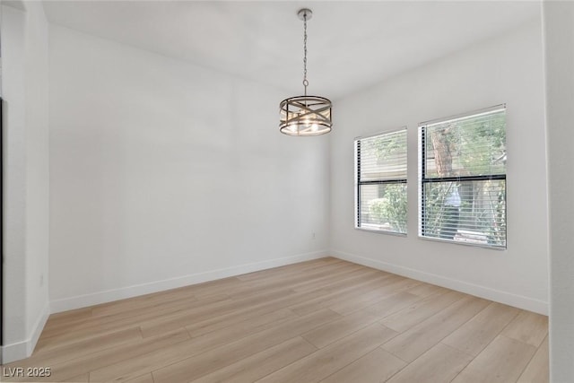 8250 N Grand Canyon Dr Unit 1050, Las Vegas, NV 89166 - unfurnished room with light wood-type flooring and a chandelier
