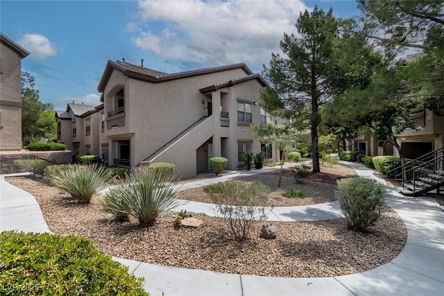 8250 N Grand Canyon Dr Unit 1050, Las Vegas, NV 89166 - view of home's exterior with stucco siding and stairway