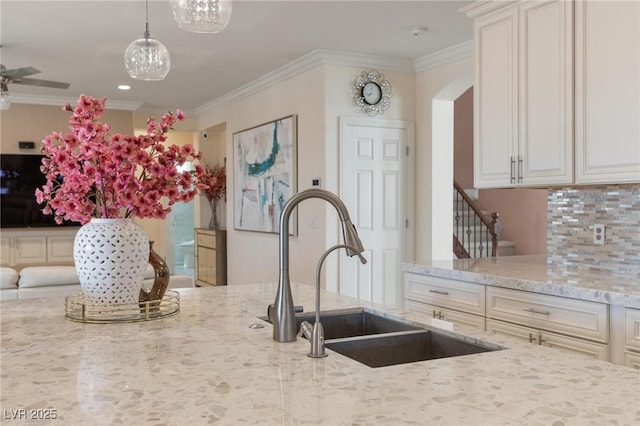 7112 Rancho De Taos Ct, Las Vegas, NV 89130 - kitchen featuring ornamental molding, light stone countertops, decorative backsplash, hanging light fixtures, and recessed lighting
