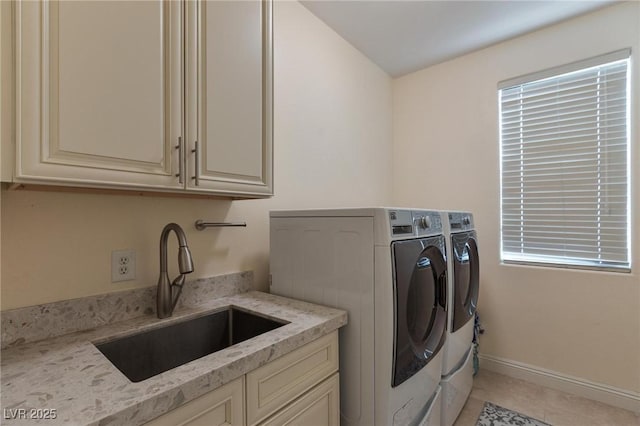 7112 Rancho De Taos Ct, Las Vegas, NV 89130 - washroom with washing machine and clothes dryer, cabinet space, and light tile patterned flooring