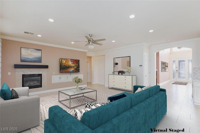 7112 Rancho De Taos Ct, Las Vegas, NV 89130 - living room featuring arched walkways, a ceiling fan, ornamental molding, a high end fireplace, and recessed lighting