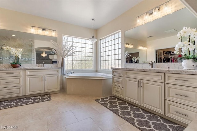 7112 Rancho De Taos Ct, Las Vegas, NV 89130 - bathroom featuring two vanities, a bath, a spacious closet, and tile patterned flooring