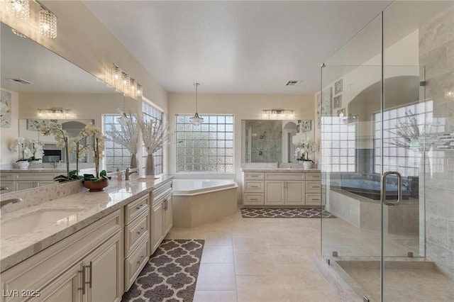 7112 Rancho De Taos Ct, Las Vegas, NV 89130 - bathroom featuring a garden tub, vanity, a stall shower, and tile patterned floors