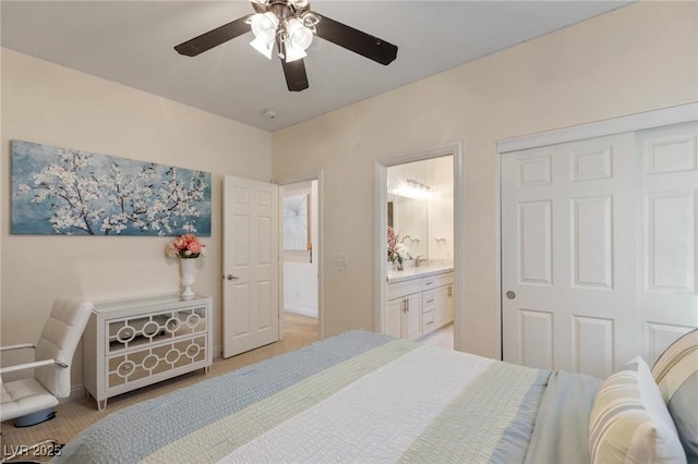 7112 Rancho De Taos Ct, Las Vegas, NV 89130 - bedroom with connected bathroom, a ceiling fan, light colored carpet, and a closet