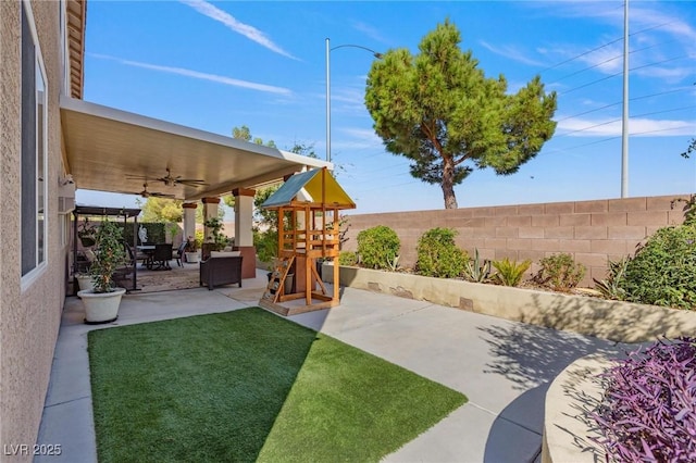 7112 Rancho De Taos Ct, Las Vegas, NV 89130 - view of yard featuring a playground, a ceiling fan, and a patio area