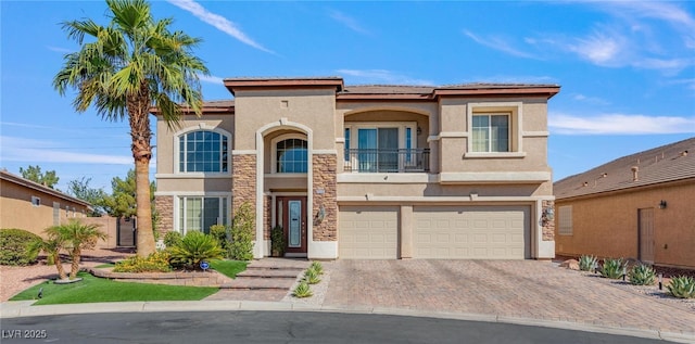 7112 Rancho De Taos Ct, Las Vegas, NV 89130 - mediterranean / spanish house with stucco siding, a garage, a balcony, driveway, and a tile roof