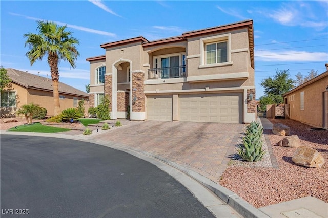 7112 Rancho De Taos Ct, Las Vegas, NV 89130 - view of front of house featuring stucco siding, stone siding, an attached garage, a balcony, and decorative driveway
