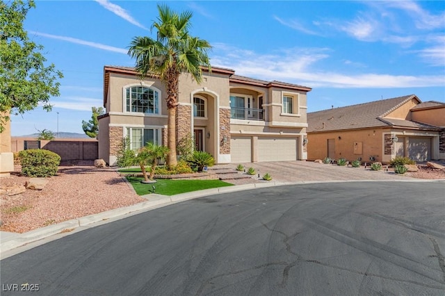 7112 Rancho De Taos Ct, Las Vegas, NV 89130 - mediterranean / spanish-style home featuring stucco siding, a garage, stone siding, driveway, and a balcony
