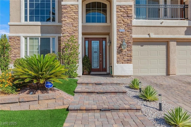 7112 Rancho De Taos Ct, Las Vegas, NV 89130 - property entrance with stucco siding, stone siding, driveway, and an attached garage