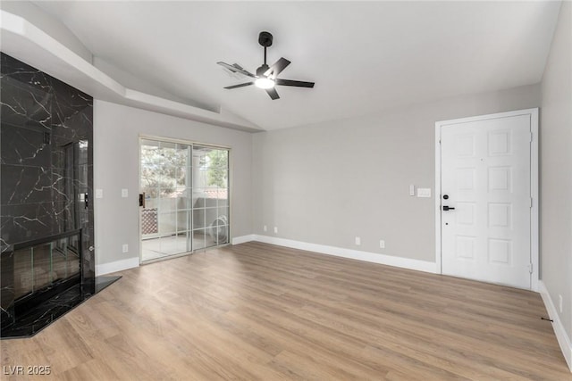 3408 Winterhaven St Unit 203, Las Vegas, NV 89108 - unfurnished living room with ceiling fan, vaulted ceiling, wood finished floors, and a premium fireplace