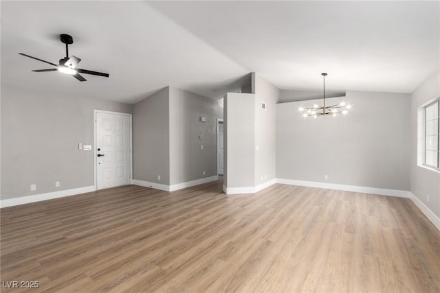 3408 Winterhaven St Unit 203, Las Vegas, NV 89108 - unfurnished living room featuring vaulted ceiling, a chandelier, light wood finished floors, and ceiling fan