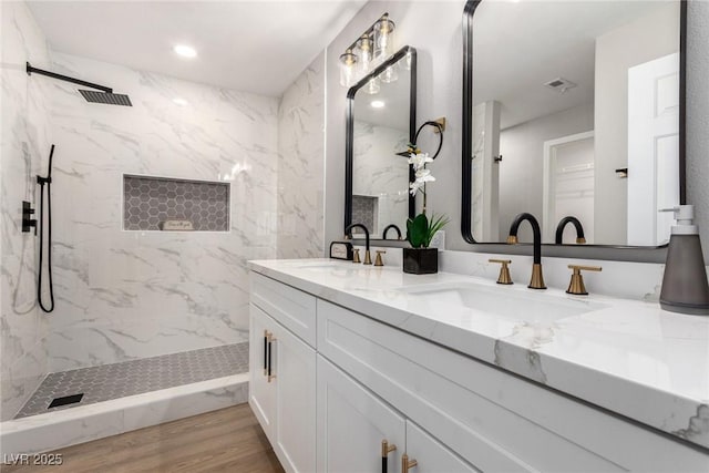 3408 Winterhaven St Unit 203, Las Vegas, NV 89108 - bathroom with double vanity, a marble finish shower, wood finished floors, and recessed lighting