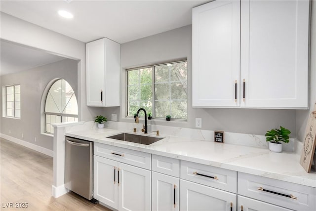 3408 Winterhaven St Unit 203, Las Vegas, NV 89108 - kitchen featuring dishwasher, light stone countertops, white cabinetry, and light wood-style floors
