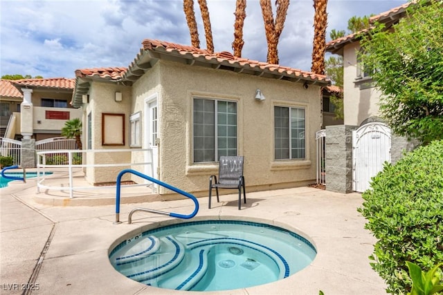 3408 Winterhaven St Unit 203, Las Vegas, NV 89108 - view of swimming pool with a patio, a community hot tub, and a gate