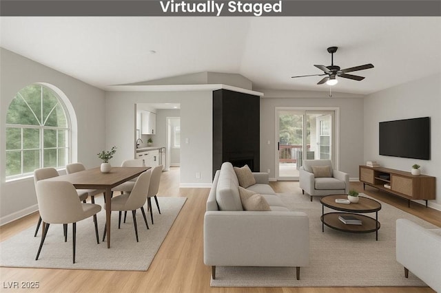 3408 Winterhaven St Unit 203, Las Vegas, NV 89108 - living room featuring light wood-type flooring, plenty of natural light, a ceiling fan, and lofted ceiling