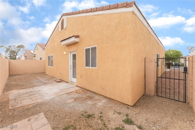1635 Otto Merida Ave, Las Vegas, NV 89106 - back of house featuring stucco siding, a gate, a fenced backyard, and a patio area