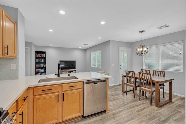9074 Maycott Ave, Las Vegas, NV 89148 - kitchen with stainless steel dishwasher, a peninsula, light wood finished floors, a chandelier, and light countertops