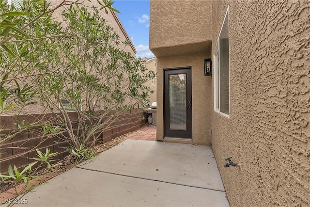 9074 Maycott Ave, Las Vegas, NV 89148 - view of exterior entry with stucco siding and a patio area